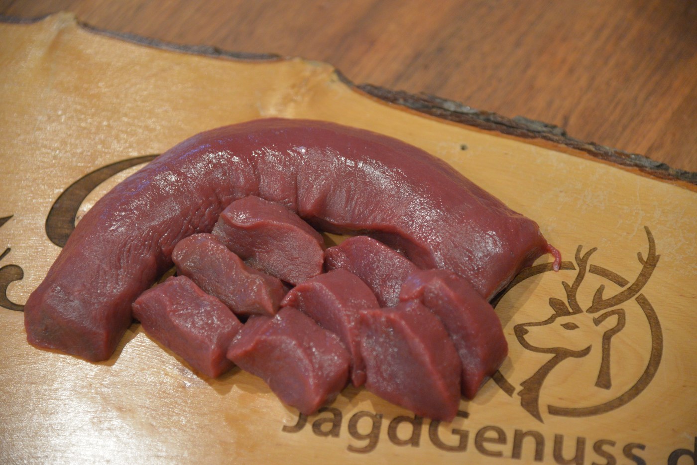 Zugeschnittenes Wildfleisch von JagdGenuss auf dem Holzbrett